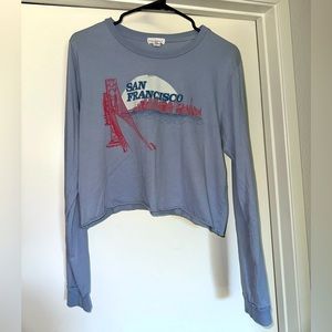 Long sleeve cropped light blue shirt.